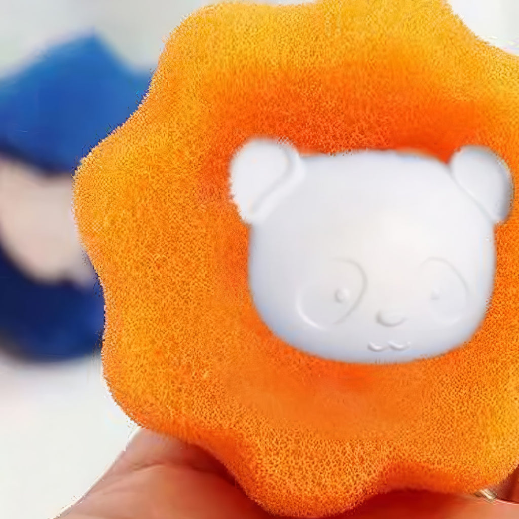 Close-up of an orange pet hair remover ball with its white bear-face center