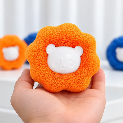 Hand holding an orange Furloop pet hair remover ball with a white bear face